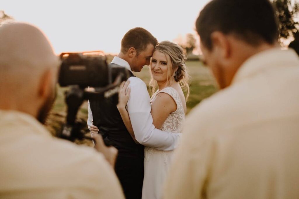 Wedding videographers filming a couple