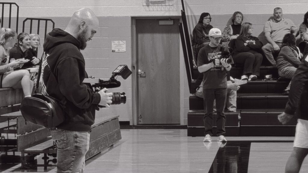 VivHaus team filming a Hillcrest Academy basketball game, demonstrating dynamic sports storytelling in action.