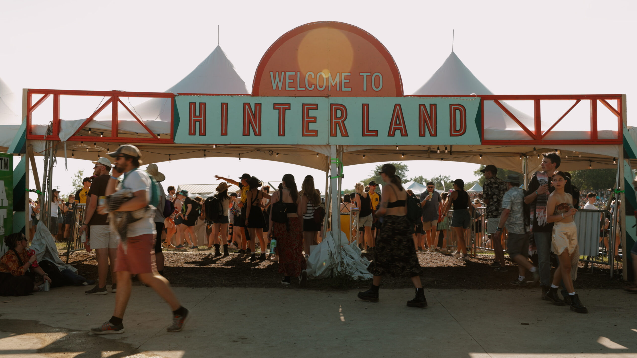 A vibrant moment from the 15-second festival TV ad for Hinterland Music Festival, showcasing a lively crowd, dynamic stage lighting, and the festival atmosphere