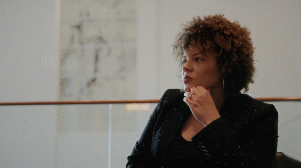 Vanessa McNeal delivering a keynote speech on confidence and leadership at a live event
